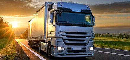 Lorry driving from sunset